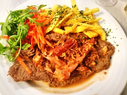 Gourmet meal shared among friends in a rustic restaurant setting. A blend of flavors and good company.