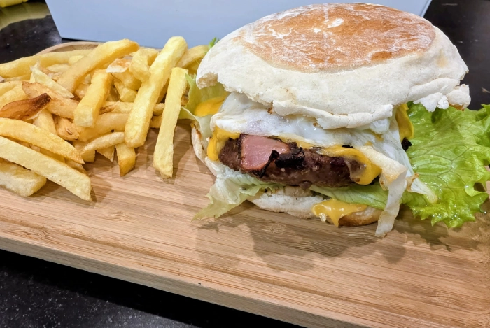 Fresh homemade flatbreads stacked with a striped cloth on a green surface. Perfect for culinary use.